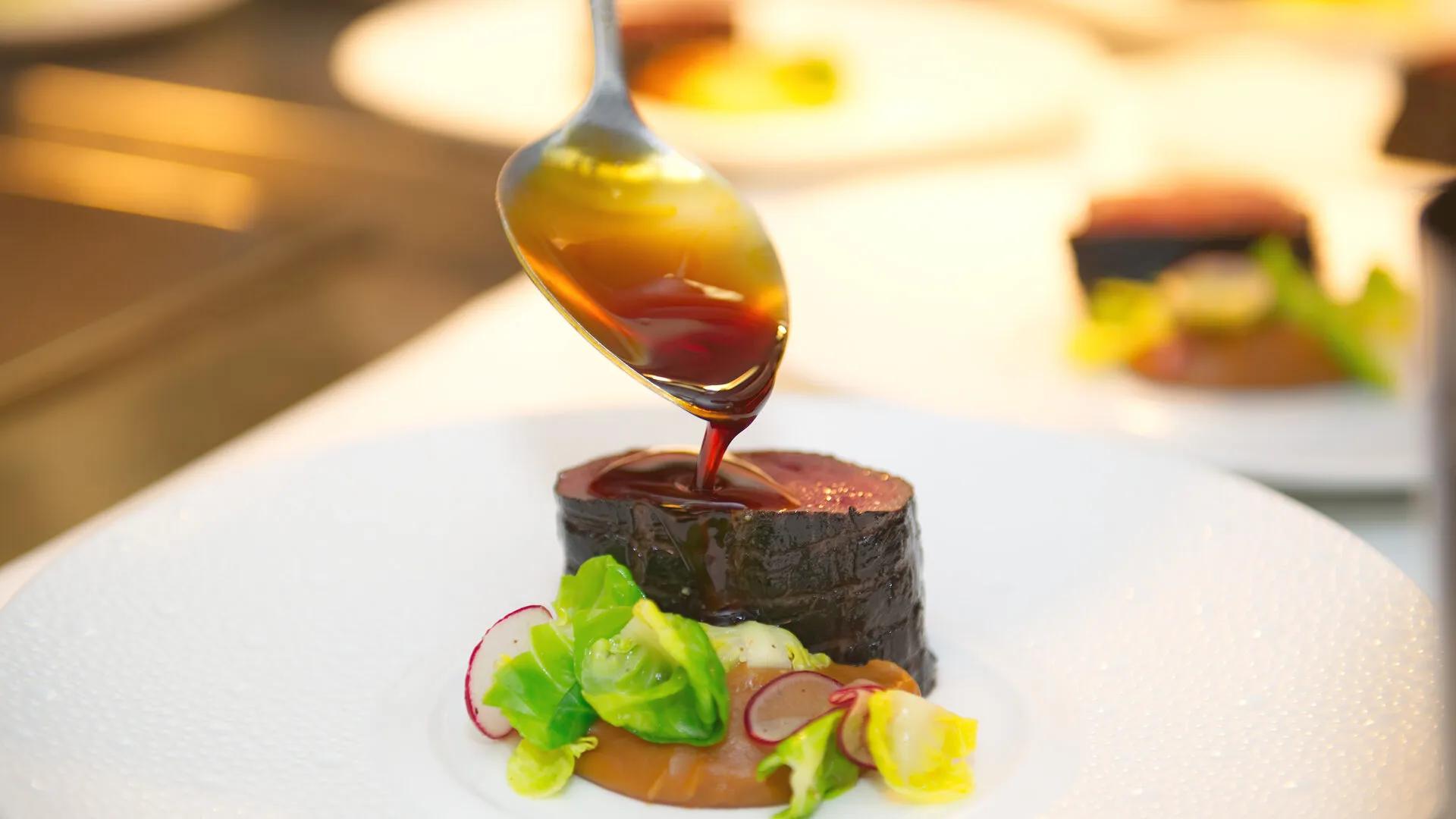 Sauce drizzled over a perfectly seared beef tenderloin