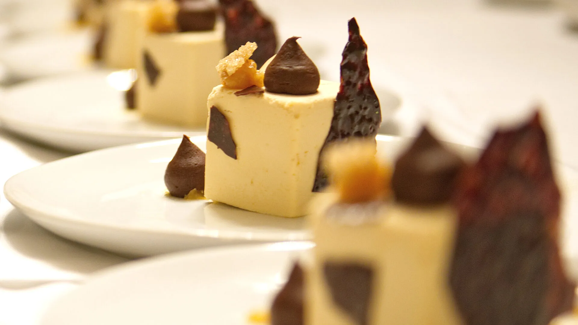 Elegant dessert plating lined up for service