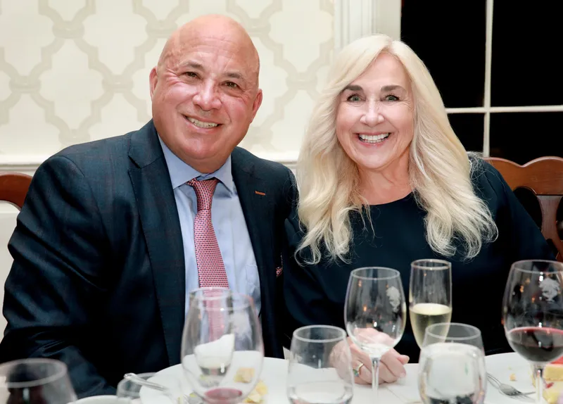 Couple posing together at their dinner table