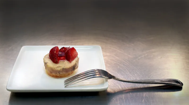 Foie gras torchon on brioche with strawberry on the kitchen prep surface
