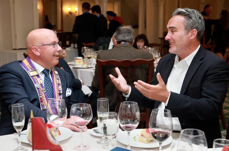 Members in animated conversation during dinner
