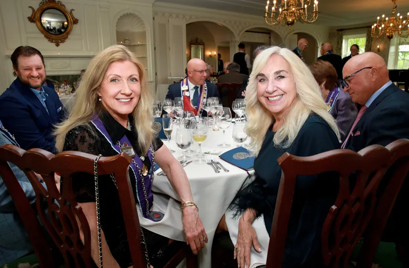 Two members in ribbons at their dinner table