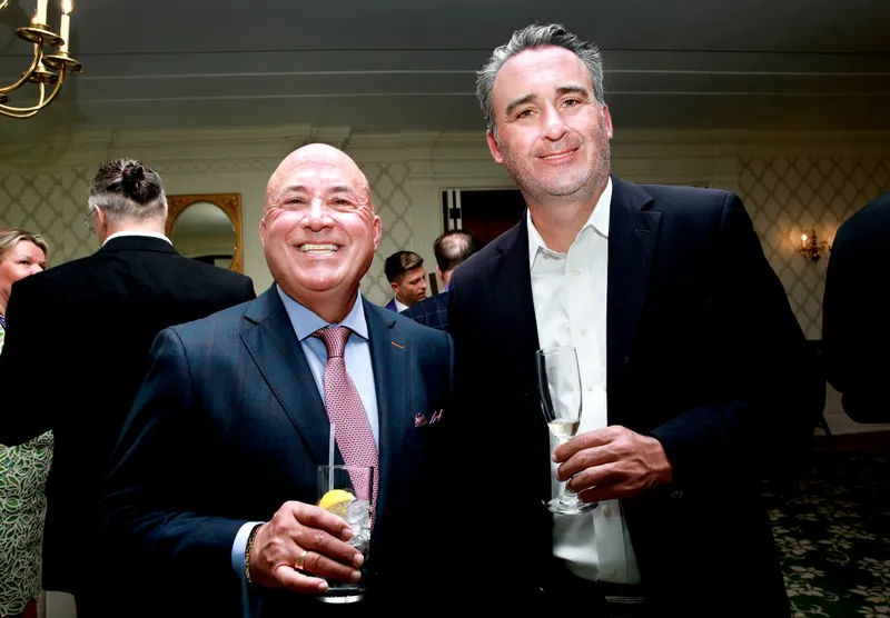 Two members in conversation during cocktail hour