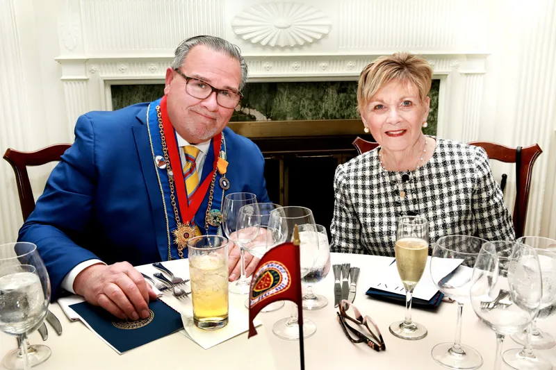 Officer and his wife seated together at the dinner