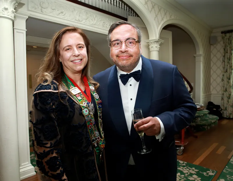 Member in a tuxedo with a Chaîne ribbon during the reception