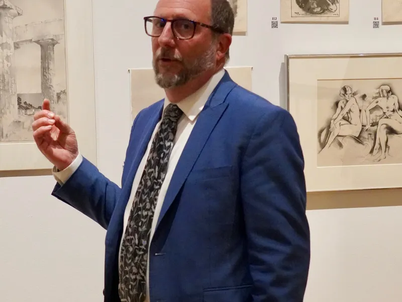 A guide leading the preview of works going up for auction