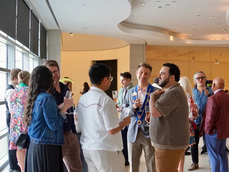 Members laughing together during the cocktail hour