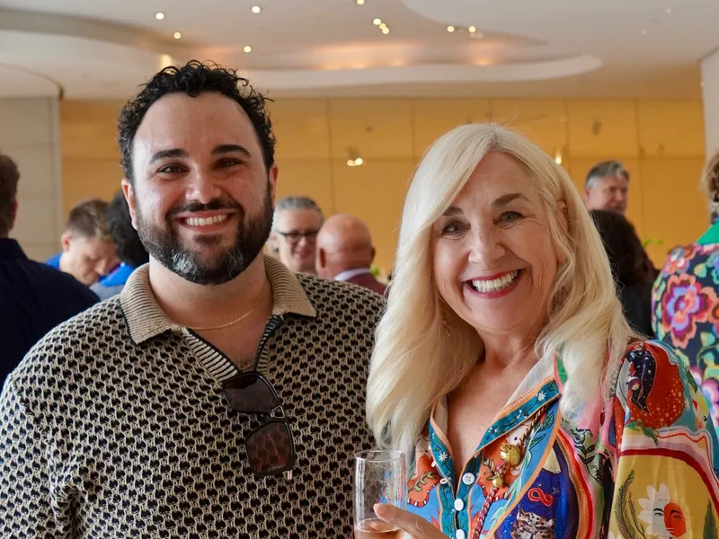 A member and guest with champagne during the reception