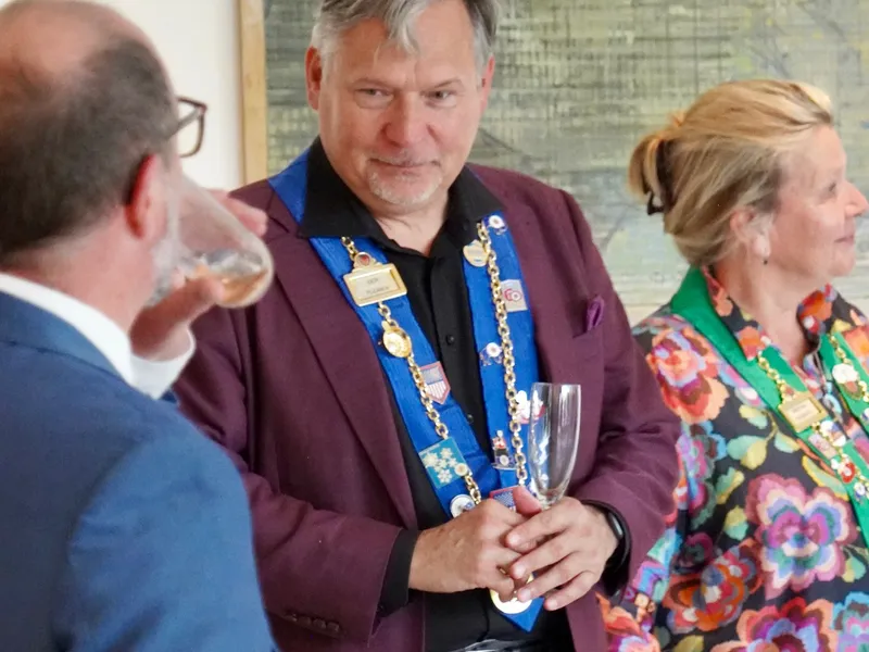 A member in his ribbon and medal in conversation during the reception