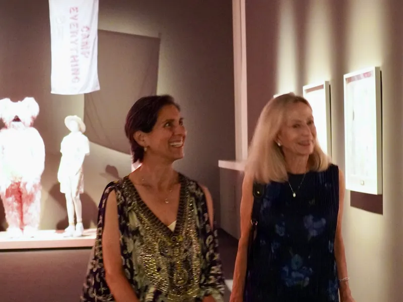 Two guests strolling through the sculpture gallery
