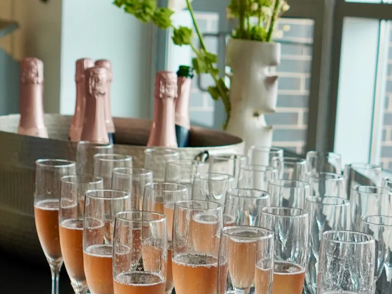 Rows of rosé sparkling wine poured and waiting at the reception