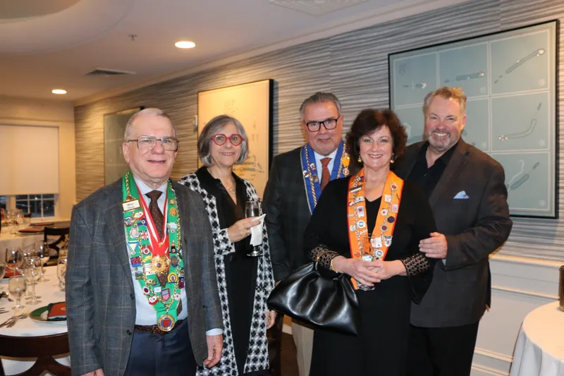 Members wearing ribbons in the dining room