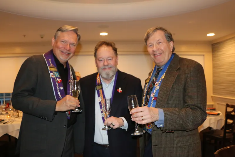 Members with champagne in the dining room