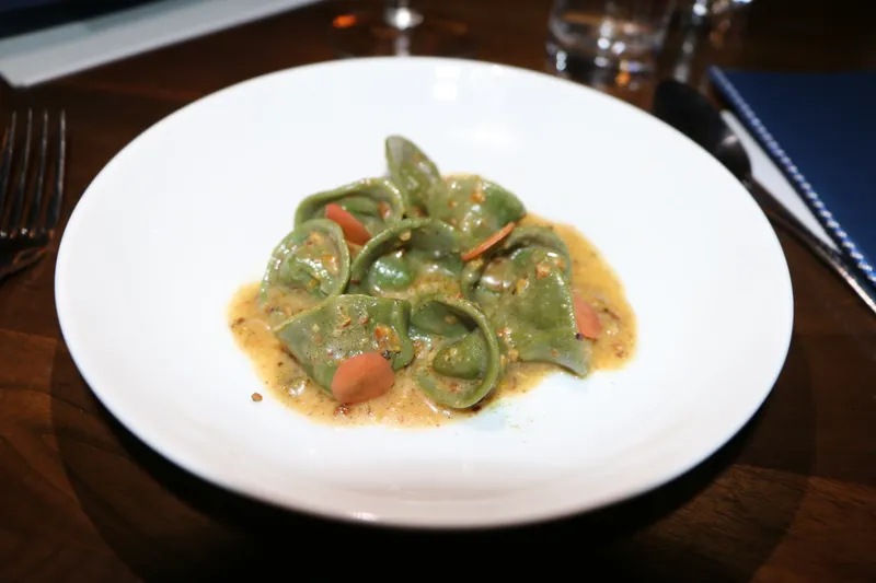 Smoked carrot tortelli with pistachio butter and baby kale