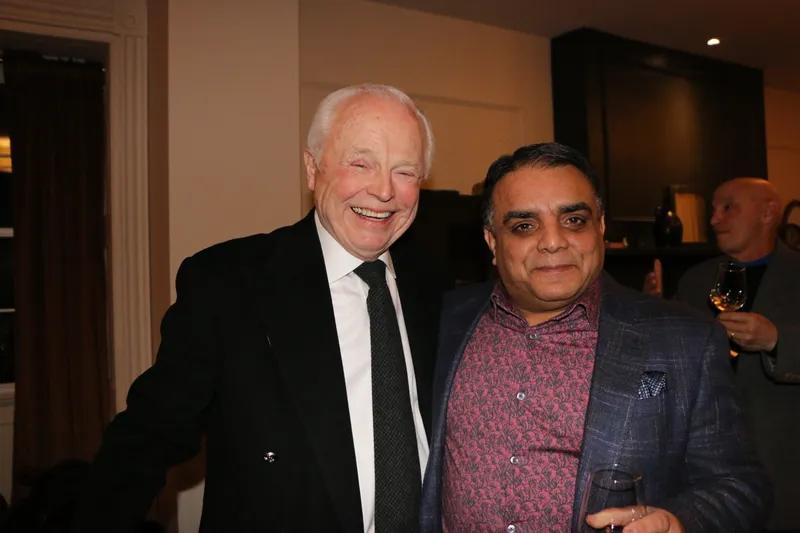 Members laughing during cocktail hour